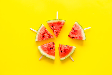 Popsicle from fresh watermelon on yellow background top view