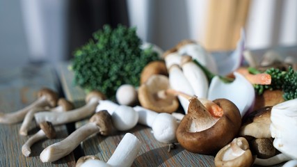 fresh mushrooms and vegetables on a chopping surface