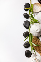 SPA background with massage compress balls, stones, sea salt, brush and teapot