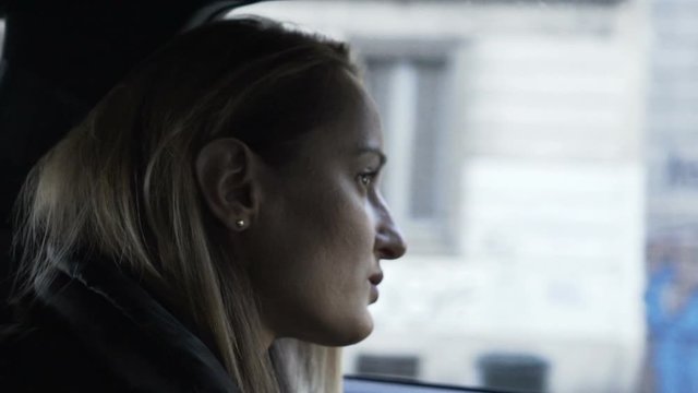 Young, pensive woman in car, slow motion 240fps