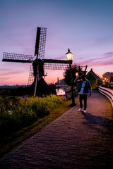 men watching Sunrise at the Zaanse Schans windmill village in the Netherlands, zaanse schans is a small wooden house village in Holland, Dutch windmills