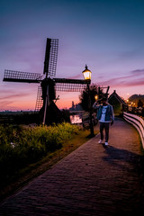 men watching Sunrise at the Zaanse Schans windmill village in the Netherlands, zaanse schans is a small wooden house village in Holland, Dutch windmills