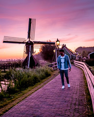 men watching Sunrise at the Zaanse Schans windmill village in the Netherlands, zaanse schans is a small wooden house village in Holland, Dutch windmills
