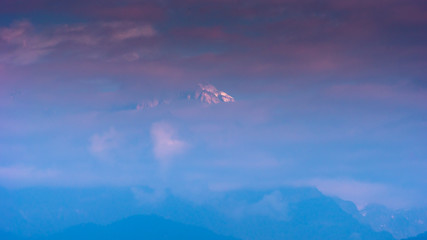 A view of Snow clad Kanchenjunga,the third highest mountain in the world, covered with clouds.