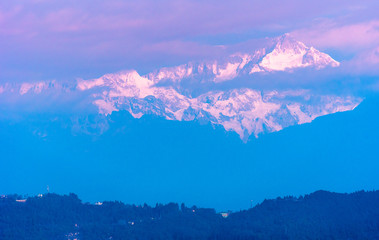 A view of Snow clad Kanchenjunga,the third highest mountain in the world, covered with clouds.