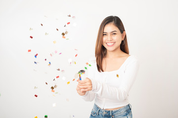 Beautiful happy woman is celebrating in studio white background