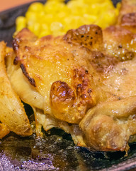 Chicken, French fries, and corn in plate