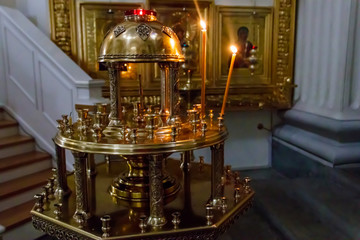 Large church candlestick with burning candles in orthodox church