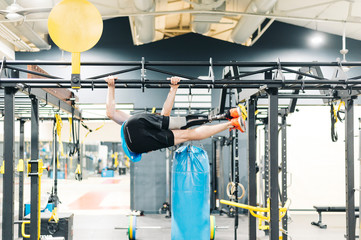 Disabled athlete with leg prosthesis training at the gym. Paralympic Sport Concept.