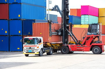 The crane is lifting the 40ft container from the truck