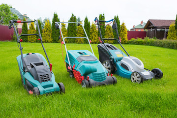 lawn mowers in the backyard. Gardening concept. Grass care.