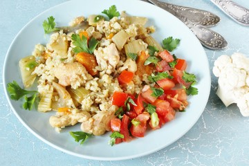 chicken pilaf and cauliflower rice. keto recipe. low carbohydrates, lots of protein. protein nutrition. stewed with celery and carrots.