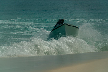 migrant boat landing on the beach