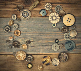 several old buttons on the vintage table surface