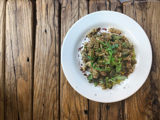Nutty Fusilli (Italian pasta) with chicken, vegetables, Arugula and pesto sauce.  Gluten free dish. Flat lay.  Top view.