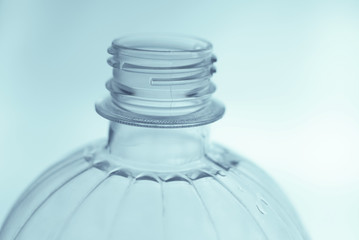  open plastic bottle on light background close up           
