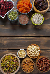 nuts, seeds and dried fruis on wooden surface