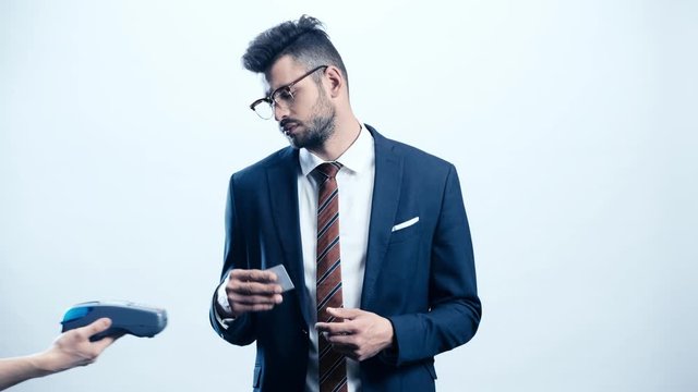handsome businessman paying by credit card on white 