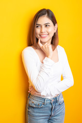 Beautiful university student is smiling on yellow background
