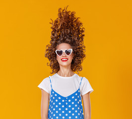 beautiful funny girl on colored yellow background.
