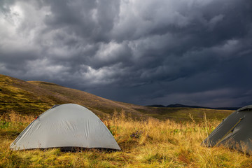 Beautiful mountain landscape in stormy weather with a tourist tent. Carpathian mountains of...
