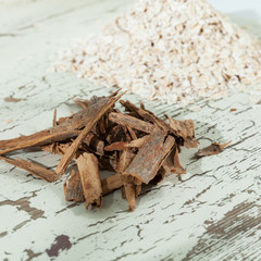 Fototapeta na wymiar oat flakes with cinnamon sticks