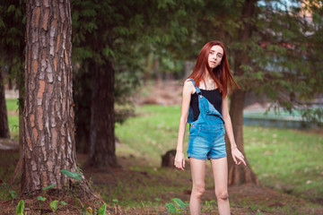 a skinny redhead girl in a brazilian forest