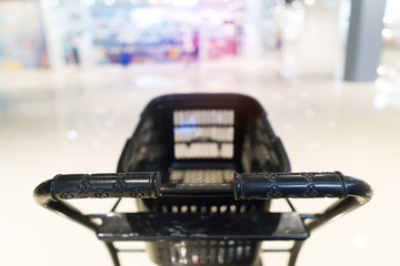 Mini cart for shopping at department store interior background.