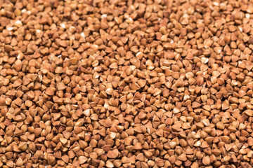 Fototapeta premium Macro Photo food buckwheat groats. Texture background grain buckwheat groats. Image food product porridge buckwheat grains