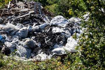Fototapeta premium environmental pollution in nature, car and machinery parts and garbage thrown into the nature.