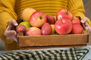 Wooden box with fruit in his hands. Healthy diet