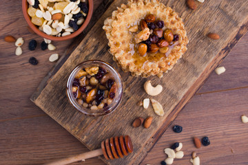 Tasty and healthy honey with nuts on the table.