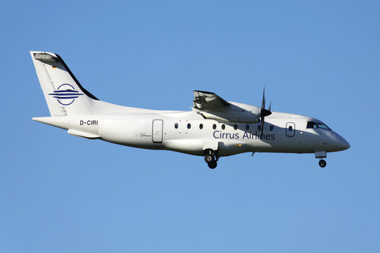 OBERGLATT, SWITZERLAND - June 26, 2011: German Cirrus Airlines Dornier 328 with registration D-CIRI on short final for runway 14 of Zurich Airport. Cirrus ceased operations on 20 January 2012.