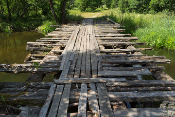 Fototapeta premium The destroyed wooden bridge.