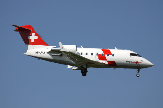 OBERGLATT, SWITZERLAND - June 27, 2011: Swiss Air Ambulance Rega Bombardier Challenger 604 with registration HB-JRA on short final for runway 14 of Zurich Airport.