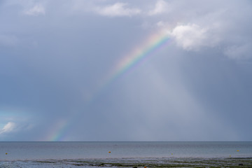 Langrune-Sur-Mer, France - 08 12 2019: Rain-laden sky and the rainbow over the sea