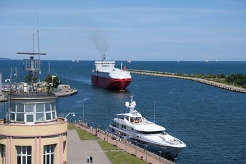 Ships in Gdansk Nowy Port (New Port), Poland. A huge red ship entering port.  View from  lighthouse.