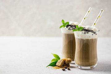 Festive coffee with whipped cream, mint, marshmallow and chocolate. Selective focus, space for text.