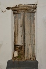 Ruined wooden door in Casares, Andalusia, Spain