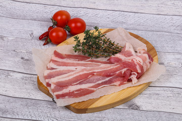 Raw bacon on the board