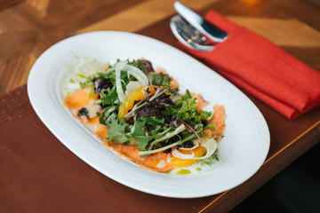 Smoked Salmon Pomelo Salad include green oak, red leaf lettuce and onion. Dressing with Thai spicy seafood salad sauce.