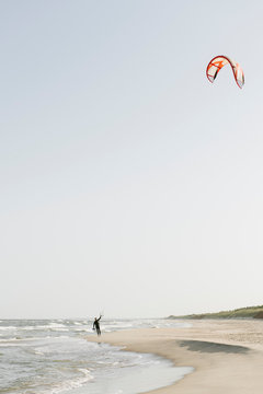 Kiteboarder preparing his kite at the beach