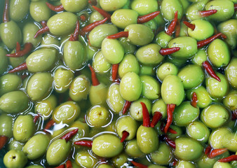 olives with hot red paper, chilli, picking from plants during harvesting, green