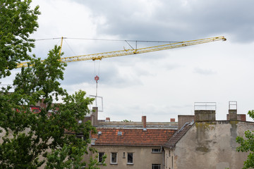 Repair restoration work in an old house in Berlin, crane with window frame