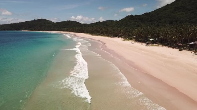 Aerial: Beautiful drone flight over the Twin Beach, Waves