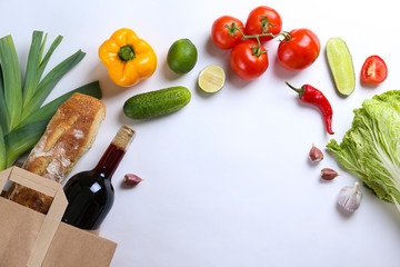 Bunch of mixed organic fruits, vegetables & greens, gourmet pile in full eco friendly shopping bag to reduce ecological footprint. Zero waste concept. White table background, copy space, close up.
