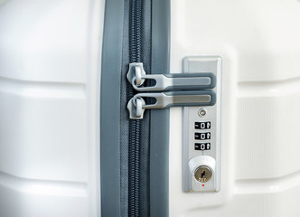 Closeup detail of a suitcase with focus on the lock password number.