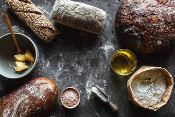 Bread on a black background. Homemade pastries with ingredients.