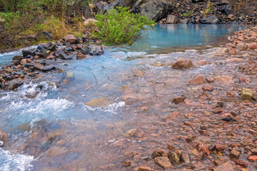 Blue spring in the mountains, source of crystal pure natural water; beginning of the river
