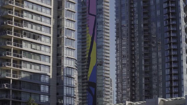 Vancouver Yaletown High rise apartments, Morning - smooth shot from moving boat in False creek, Canada